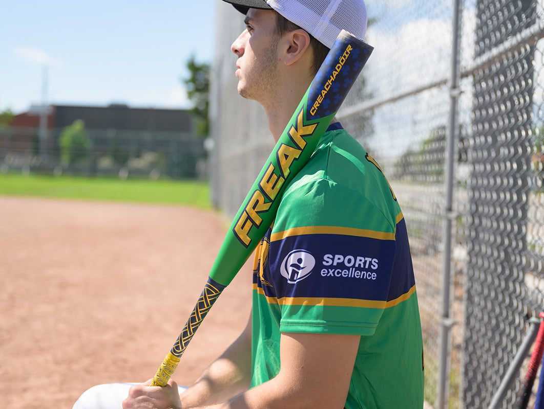 a slow pitch softball player holding his Miken Freak Creachadoir slowpitch softball bat