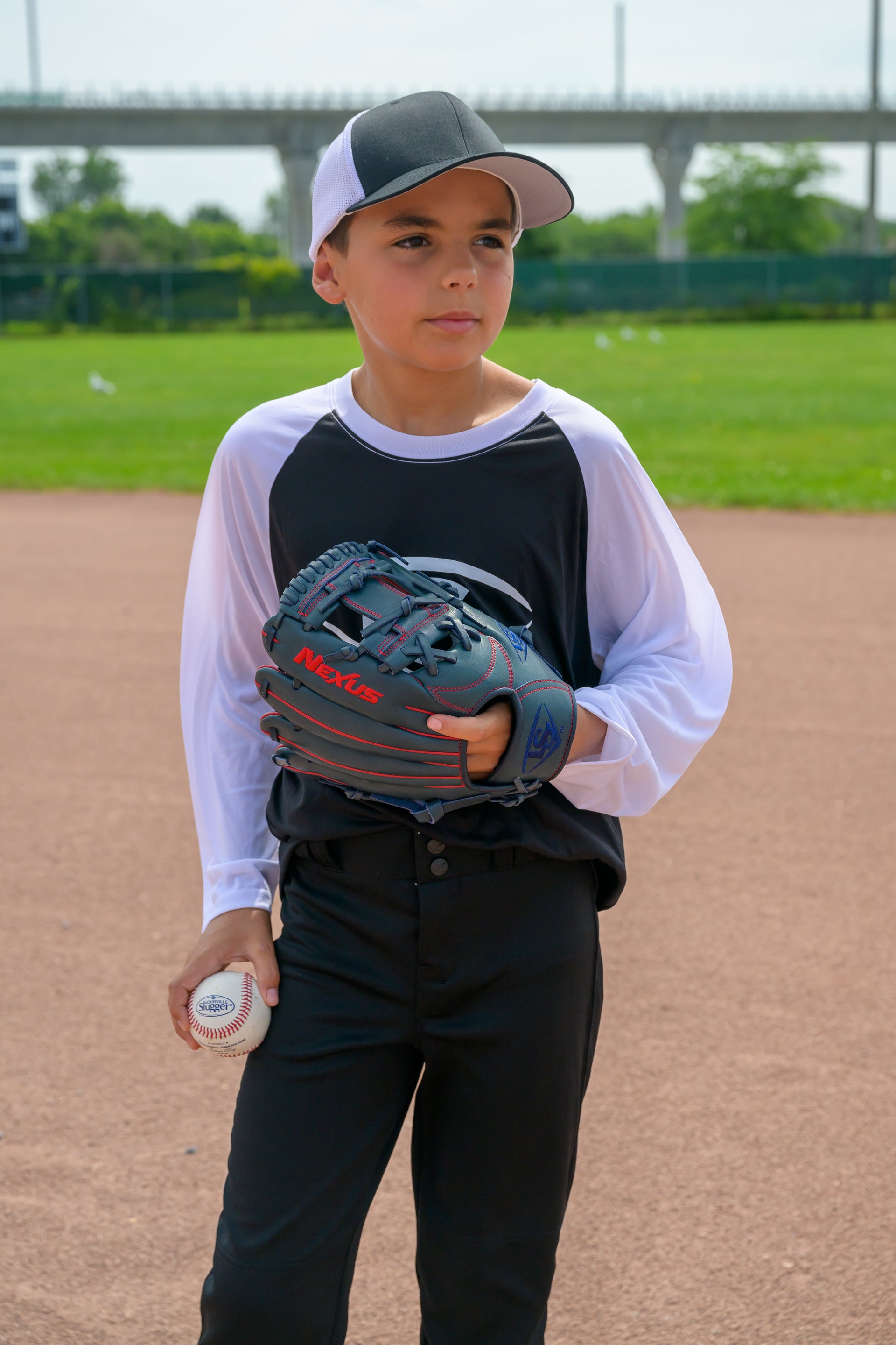 A baseball player wearing a Nexus baseball glove