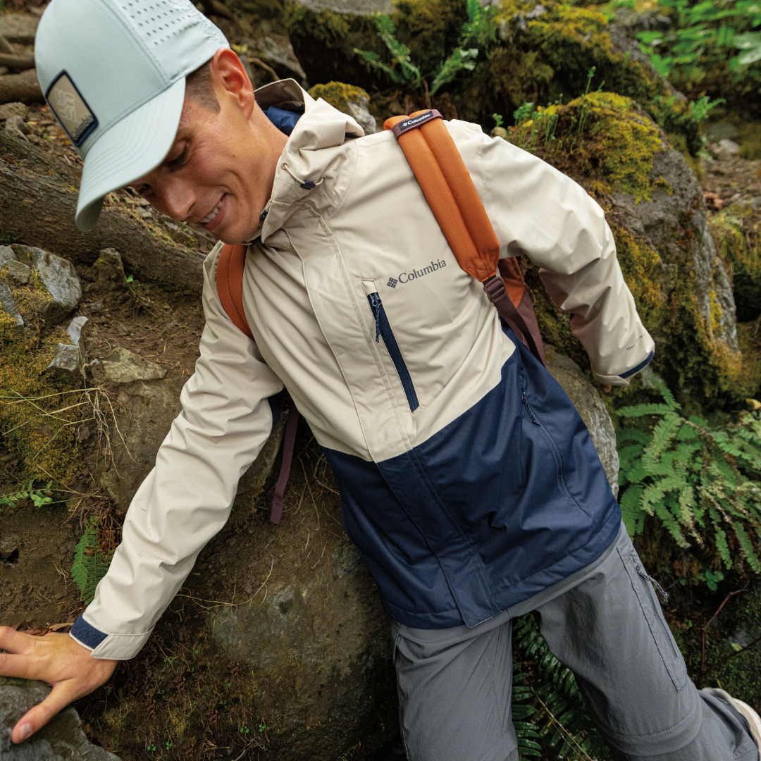 A hiker wearing the Columbia Hikebound rain jacket
