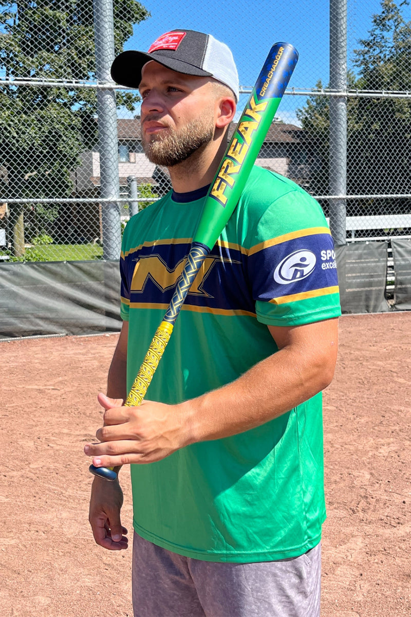 Baseball player holding the Miken Freak Creachadoir slowpitch softball bat