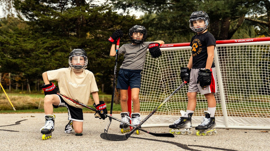 Three hockey players playing street hockey in their Bauer Vapor Rollers