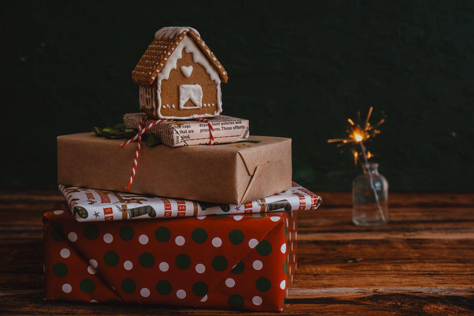 A christmas gift with a gingerbread house and christmas wrapping paper