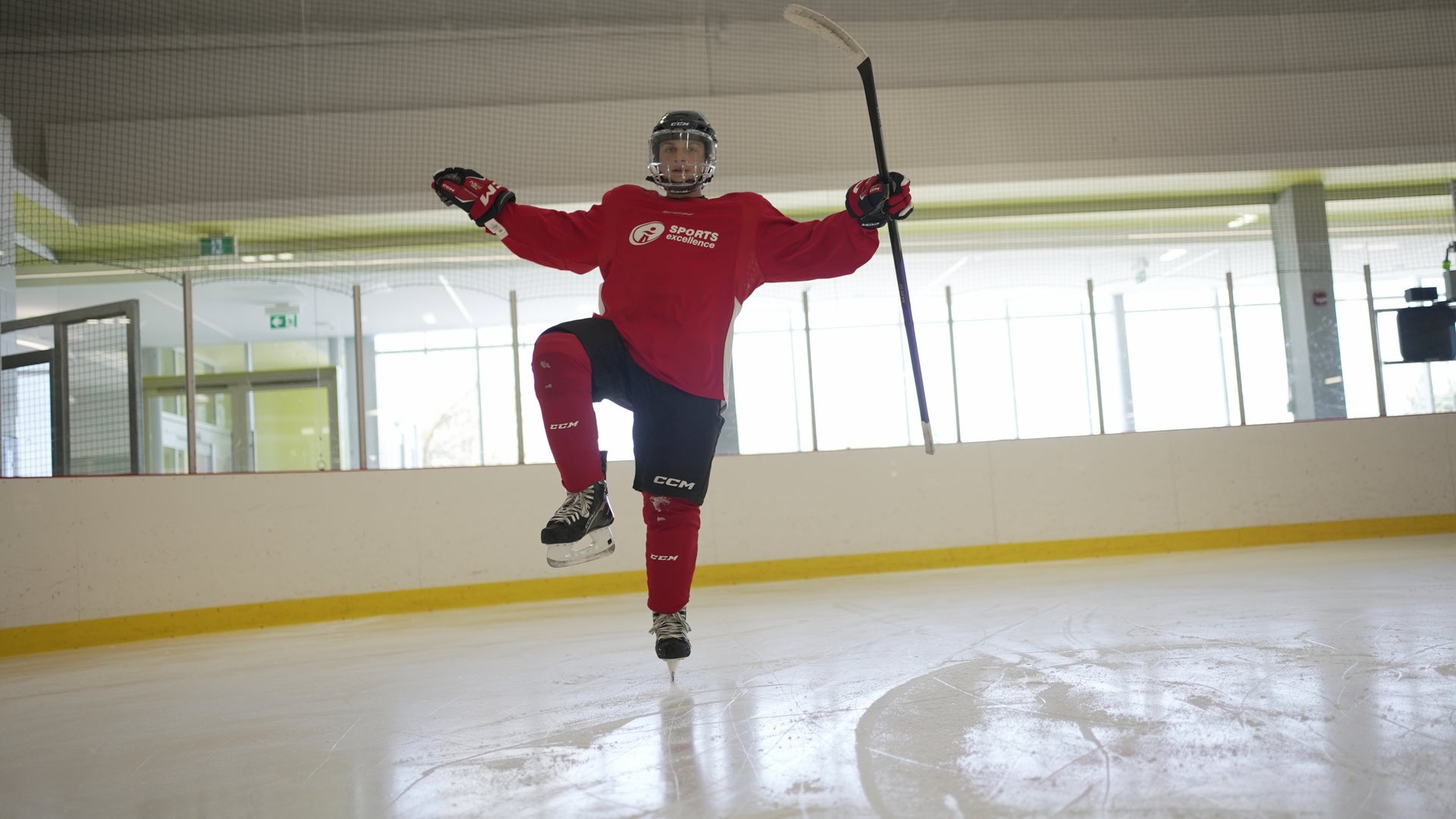 A hockey player wearing CCM hockey skates, CCM hockey skates and wearing a Sports Excellence Hockey jersey